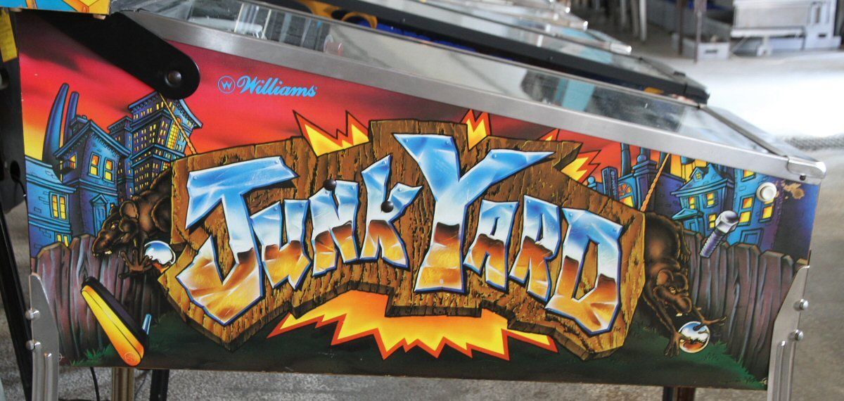 The graffiti-style Junk Yard logo on the side of a real cabinet.